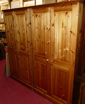 Lot 1236 - A pair of modern pine double door wardrobes, w....