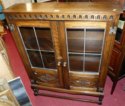 Lot 1243 - A contemporary oak double door glazed bookcase,...