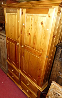 Lot 1250 - A modern pine double door wardrobe, having...
