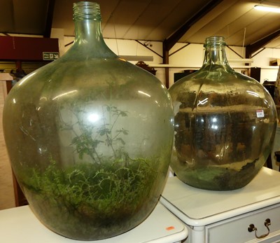 Lot 1280 - Two large tinted glass carboys of good size,...