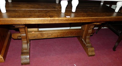 Lot 1282 - A plank top oak refectory type coffee table,...