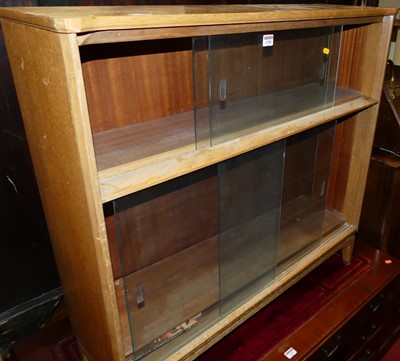 Lot 1290 - A 1970s light oak low bookcase with four...