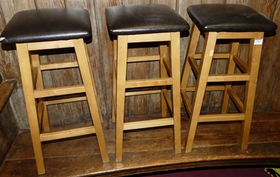 Lot 1383 - Three contemporary beech and leather topped...