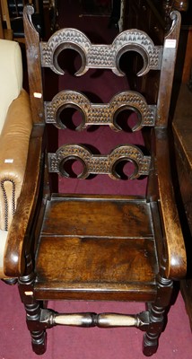 Lot 1450 - A joined oak panelled seat elbow chair, having...