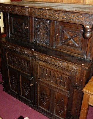 Lot 1467 - An antique floral relief carved oak court...