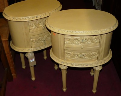 Lot 1469 - A pair of French pained oval two-drawer...