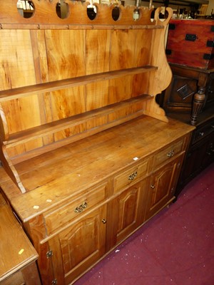 Lot 1494 - A rustic elm dresser, having three-tier open...