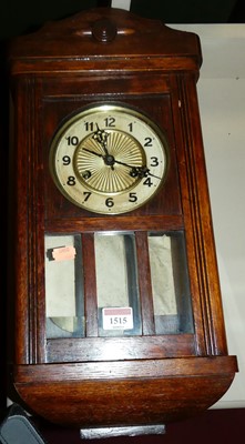 Lot 1515 - A 1930s oak droptrunk wall clock, with...