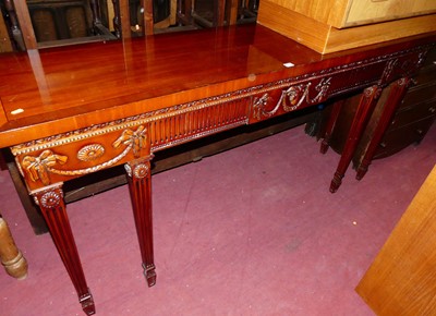 Lot 1522 - A contemporary mahogany long console table, in...