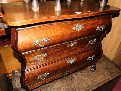 Lot 1459 - A Dutch oak low bombe chest of three long...