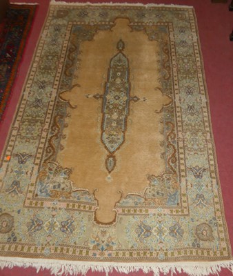Lot 1170 - A Persian woollen pale ground rug, with...
