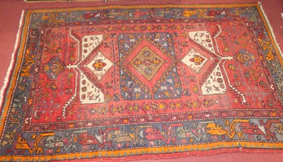 Lot 1171 - A Persian woollen red ground Shiraz rug, 195 x...