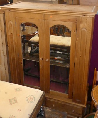 Lot 1188 - A modern pine double mirror door wardrobe,...