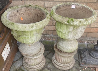 Lot 1150 - A pair of reconstituted circular footed garden...