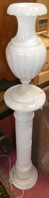 Lot 1379 - A contemporary turned alabaster pedestal lamp,...
