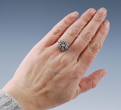 Lot 2679 - A yellow and white metal diamond flower shaped...