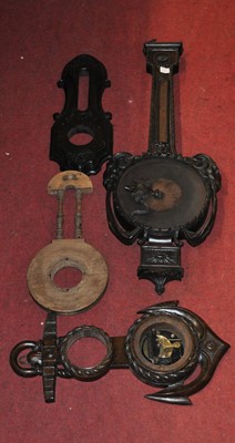 Lot 2038 - A late Victorian carved oak wheel barometer...