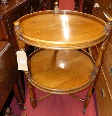 Lot 1296 - A 1930s oak circular two-tier tea trolley,...