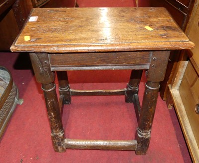Lot 1300 - An antique joined oak joint stool, raised on...