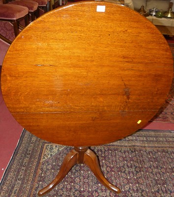 Lot 1356 - An early 19th century oak circular tilt-top...