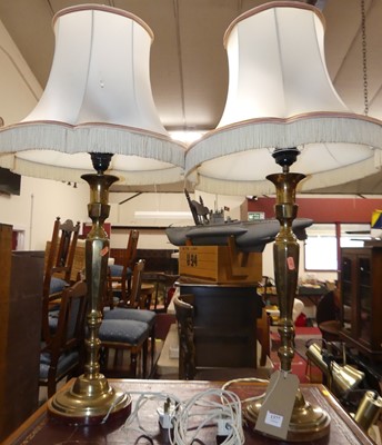 Lot 1377 - A pair of turned and polished brass table...