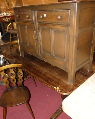 Lot 1396 - An Ercol dark elm dining suite, comprising;...