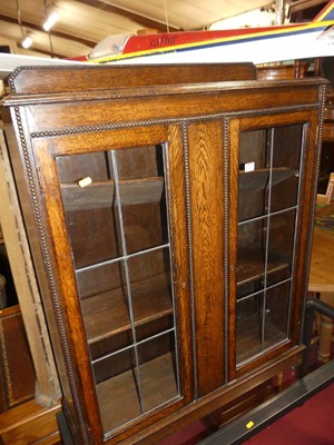 Lot 1402 - A 1930s beaded oak ledge back double door lead...
