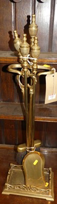 Lot 1412 - A brass companion set on stand