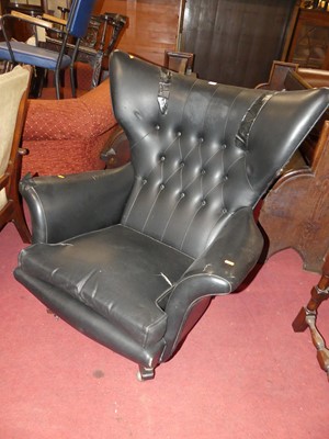 Lot 1435 - A 1960s black vinyl buttoned winged swivel...