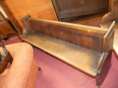Lot 1436 - A late Victorian panelled back oak long church...