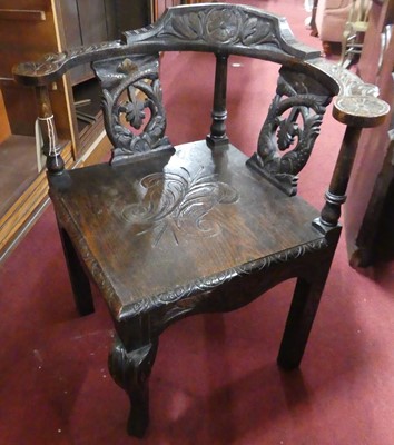 Lot 1437 - A circa 1900 relief carved oak panelled seat...