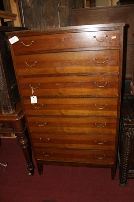 Lot 1468 - A 1960s walnut chest of seven long drawers, on...
