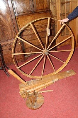 Lot 1500 - A large stained pine spinning wheel (currently...