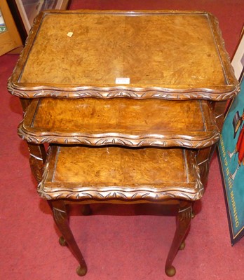 Lot 1239 - A figured walnut nest of three occasional...