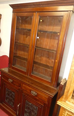 Lot 1154 - An Edwardian walnut bookcase cupboard, having...