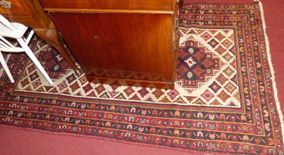 Lot 1173 - A Caucasian woollen cream and red ground rug,...