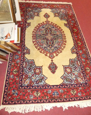 Lot 1174 - A Persian woollen cream ground Shiraz rug,...