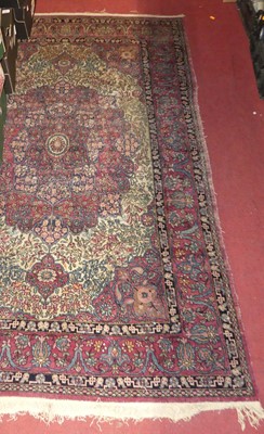 Lot 1175 - A Persian woollen red ground Tabriz rug, with...