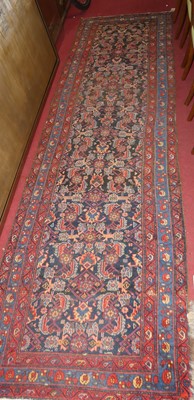 Lot 1178 - A Persian woollen blue ground Tabriz long hall...