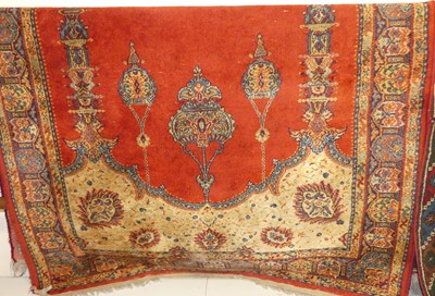 Lot 1183 - A Persian style red ground woollen rug, approx...