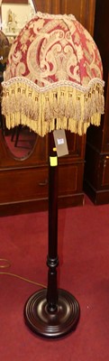 Lot 1201 - A reproduction mahogany standard lamp, with...