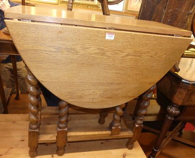 Lot 1249 - A 1930s pale oak barley twist drop leaf...