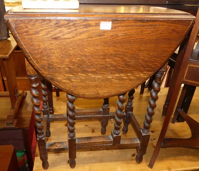 Lot 1254 - A 1920s barley twist oak drop leaf gateleg...