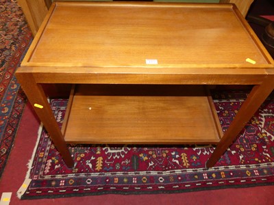 Lot 1273 - A 1970s teak two-tier tea trolley, width 71cm