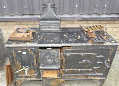 Lot 1400 - A cast iron freestanding range cooker, titled...