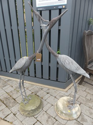 Lot 1408 - A pair of cast metal garden statues of...