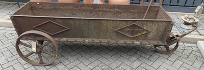 Lot 1411 - A long wheeled cast iron water trough, of...