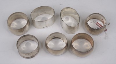 Lot 302 - A set of four circular silver napkin rings;...