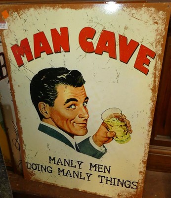 Lot 1143 - A modern printed metal wall sign reading Man...