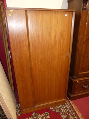 Lot 1219 - A 1960s teak tambour single door wardrobe, w.90cm